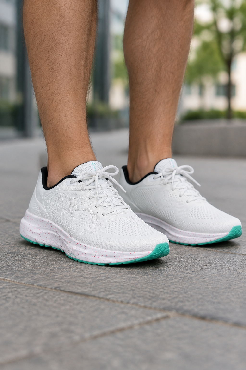 Fehér-türkiz Under Armour Charged Pursuit 4 BL cipőpár férfilábon, 3/4-es nézet
